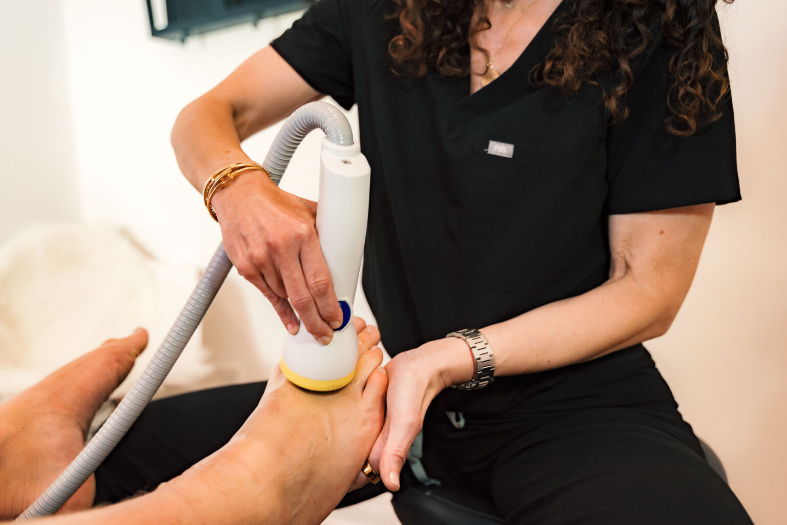 SoftWave therapy being performed on a patient's foot at Harbor Family Chiropractic